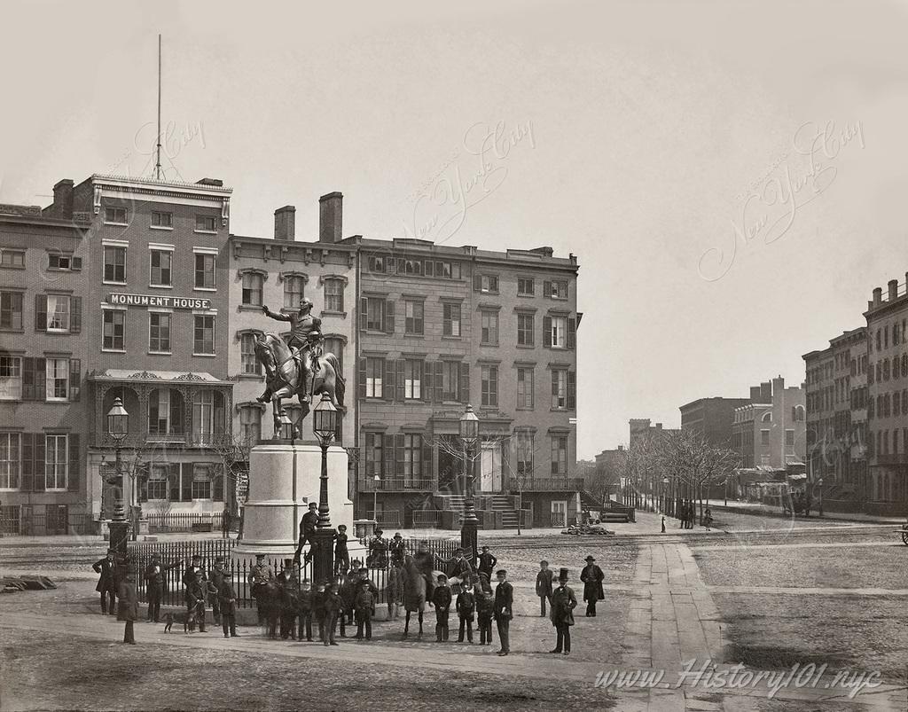 A group gathered around the newly constructed monument of George Washington in Union Square, dedicated in 1856 the the oldest sculpture in any NYC Park.