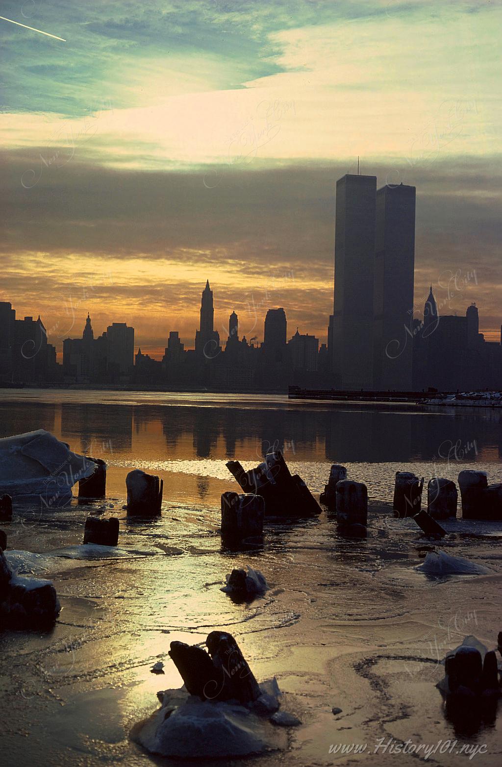 Photograph taken from Brooklyn shows the World Trade Center over a partially frozen East River.