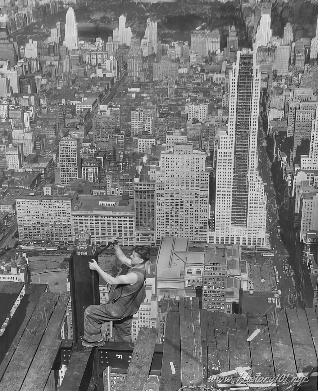 Aerial photograph of a lone construction worker working on the steel structure of the Empire State Building.