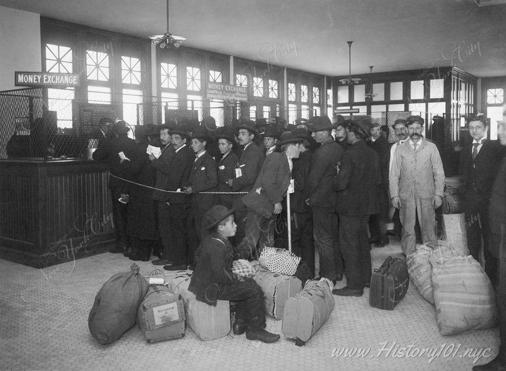 Immigrants ready for travel with baggages lined up at teller's windows marked money exchange.