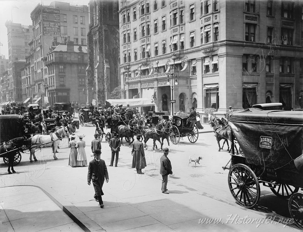 The street is packed with the traffic of horses and carriages at the intersection of 5th Avenue and 59th Street.