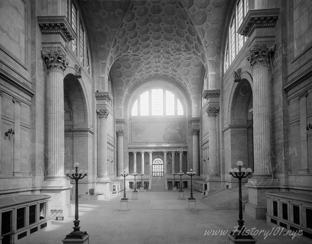 Interior view of Penn Station's famously opulent waiting room, with its high vaulted ceilings and turn-of-the-century stonework.
