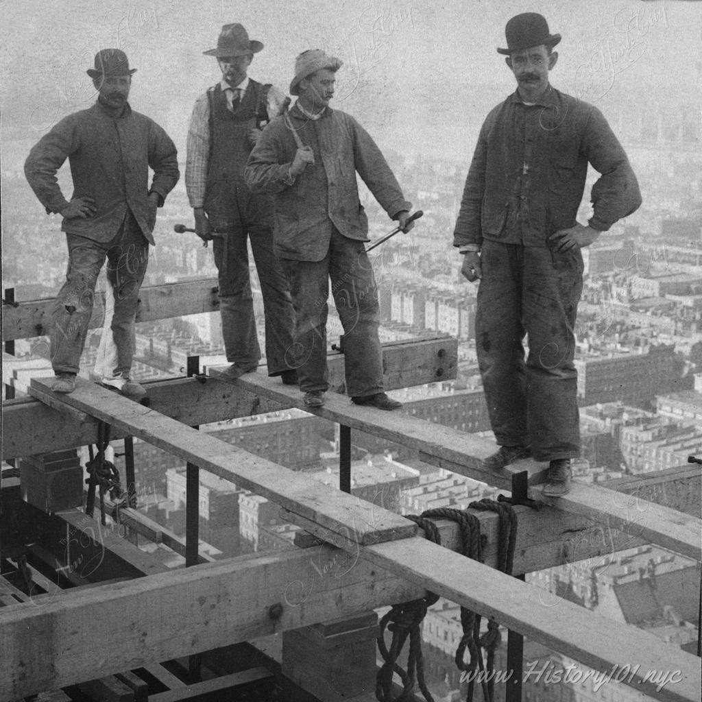 Workmen risking their lives 27 stories above ground at the construction site of the new "Times" Building, New York City.