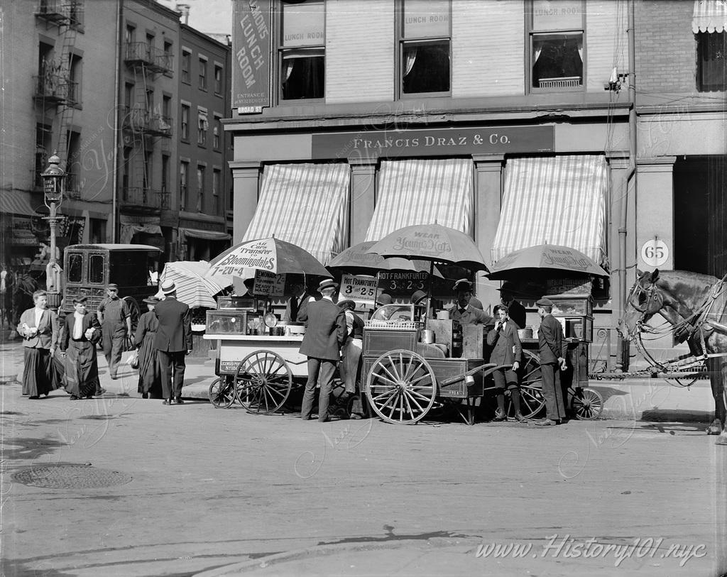 Street vendors selling hotdogs and lemonade on Broad Street in Manhattan.