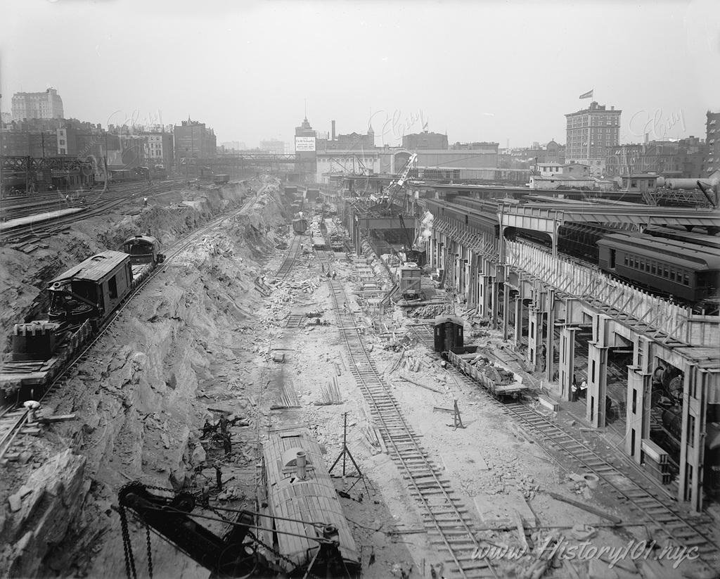 Construction workers clear several stories of earth and rock to lay the groundwork for what would become one of the city's most busy transit network.