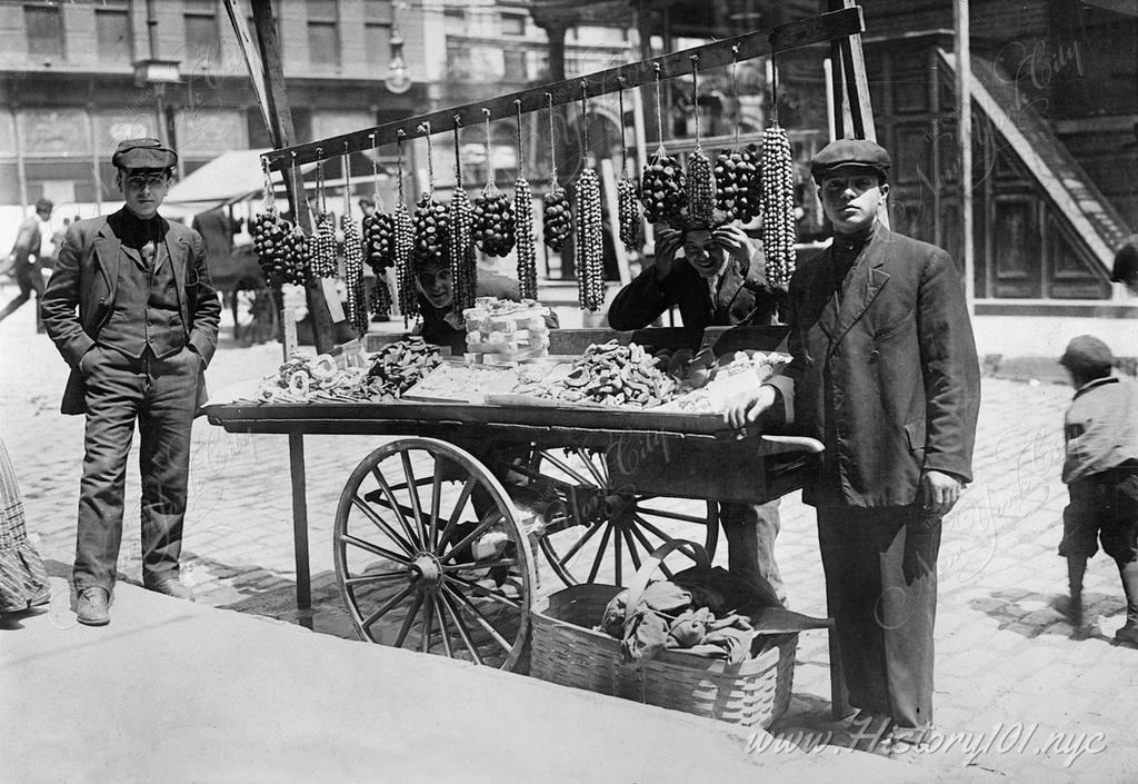 A few of many street vendors selling their goods at the Italian Feast of San Gennaro, which is still celebrated in a similar manner today.