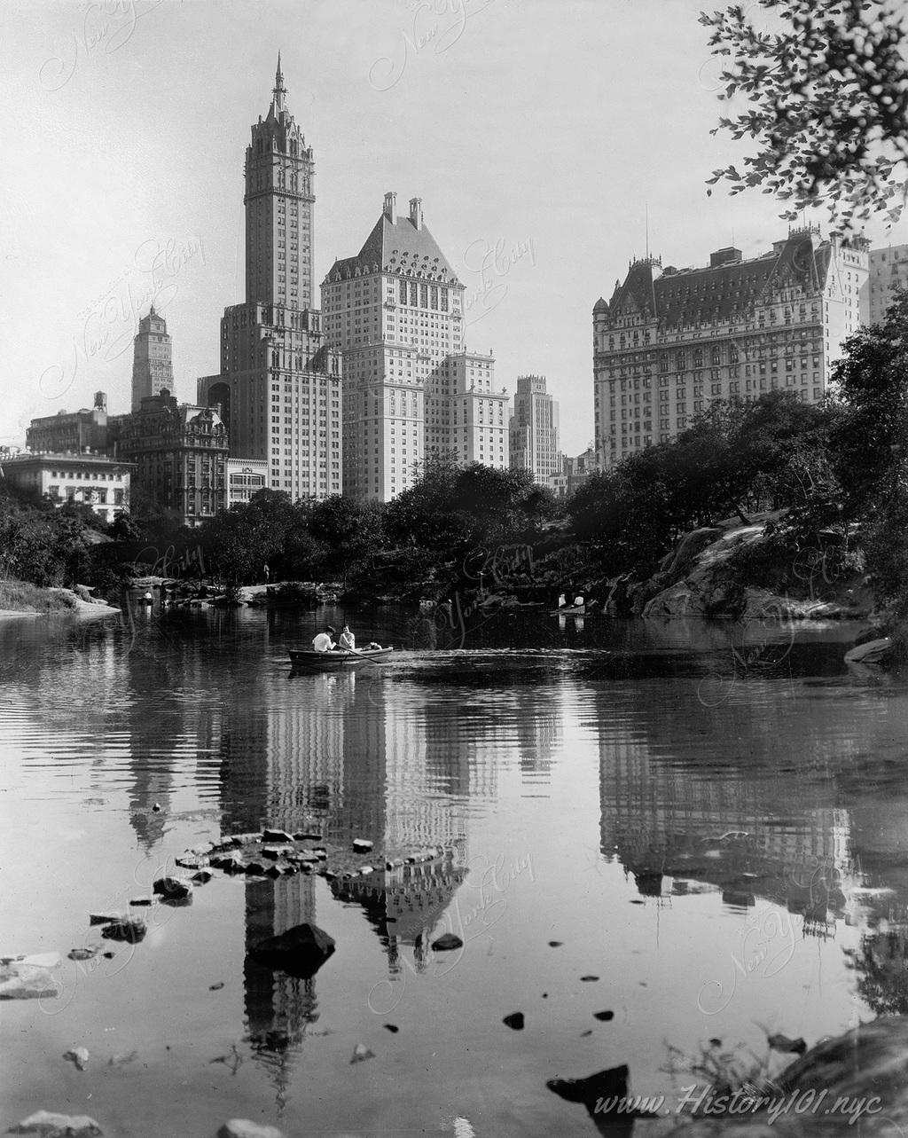 A photograph shot from the perspective of the lake at Central Park towards the luxury hotels which form the skyline.