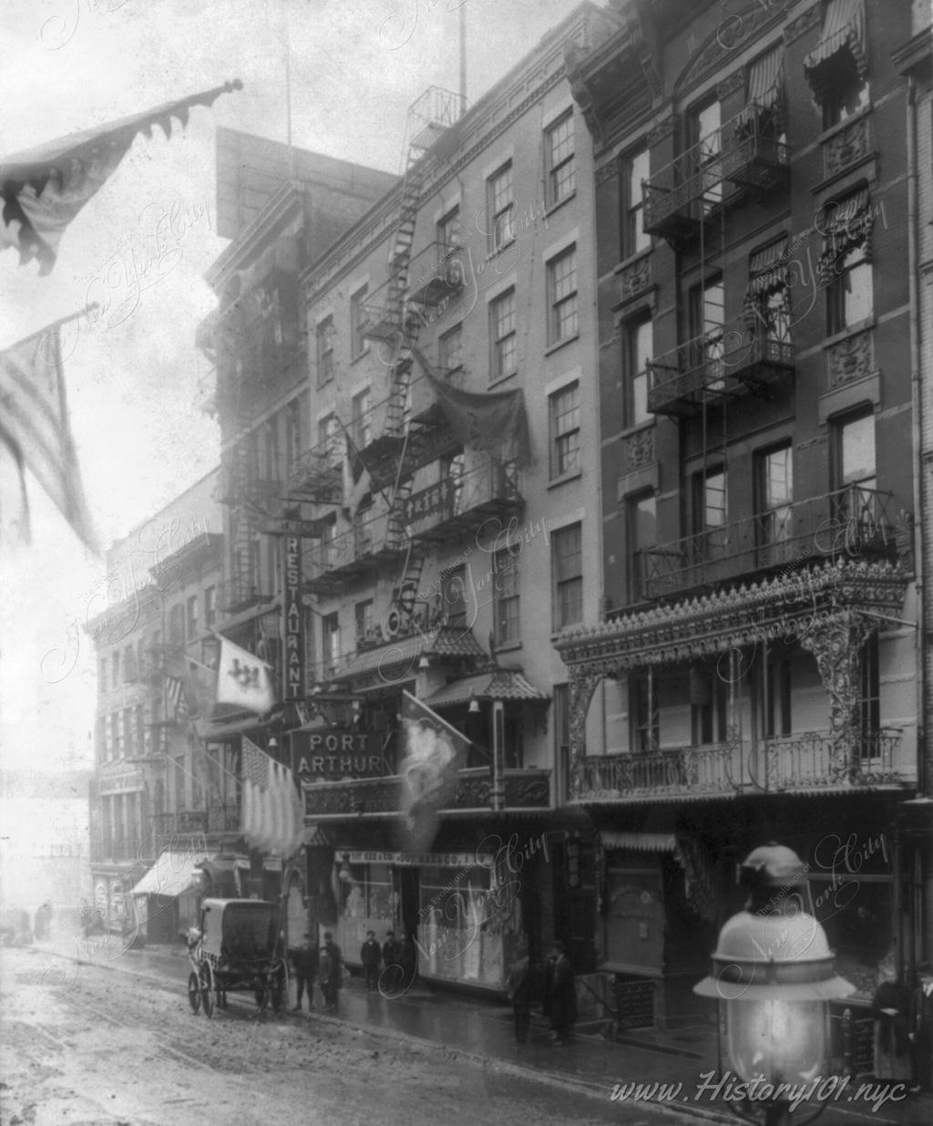 Photograph of Mott Street decorated for New Year, Jan. 21, 1909 - looking toward Port Arthur restaurant.