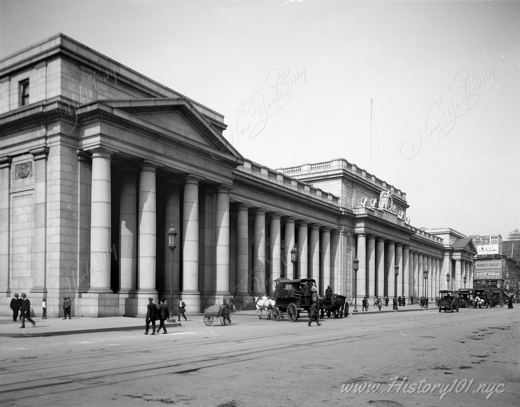 Pedestrians walk in front of the recently completed Penn Station - whose opulence and grand design would make it one of the city's most cherished landmarks.