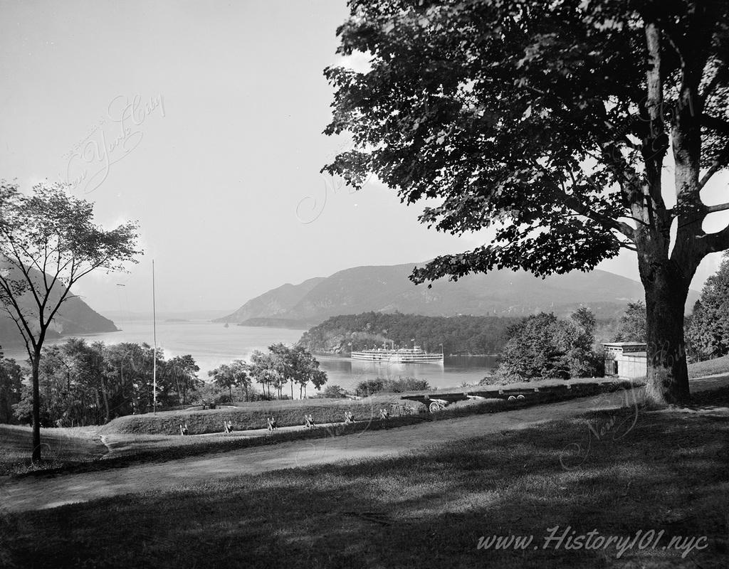 Panoramic vista of the Hudson River  Narrows and its once rural environment. A large cruise ship is seen making its way north along the river.