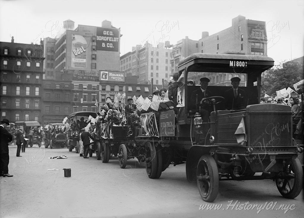 Photograph of automobiles lined up to take orphans for a day of fun at Coney Island's famous Luna Park thanks to the efforts of local charities. 