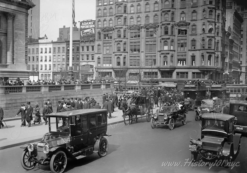 Photograph of a crowded Fifth Avenue filled with pedestrians and automobiles on Easter Sunday.