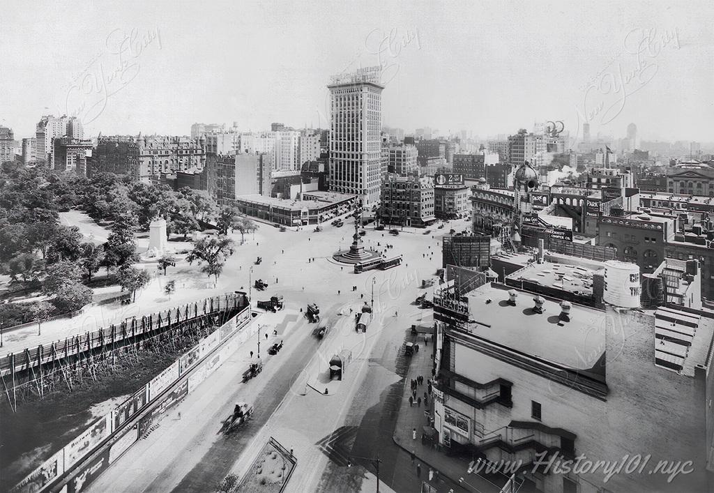 An aerial perspective of Columbus Circle and Central Park, looking south. The Circle Theater is visible in the foreground.