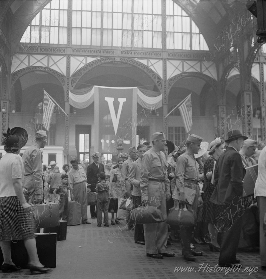 Soldiers and sailors line up inside the concourse of Pennsylvania Station.