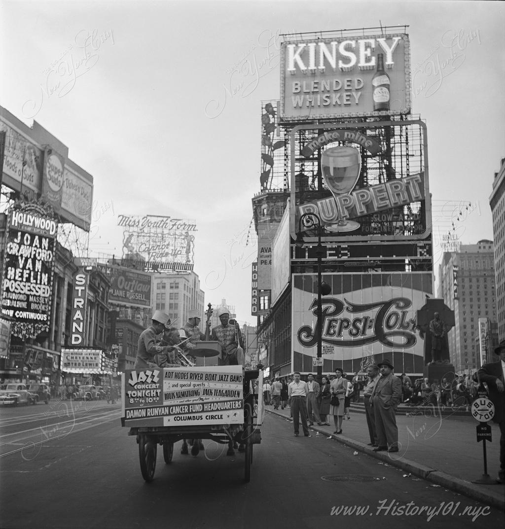 A portrait of musicians Art Hodes, Kaiser Marshall, Henry (Clay) Goodwin, Sandy Williams, and Cecil (Xavier) Scott, playing on the back of a wagon in Times Square.