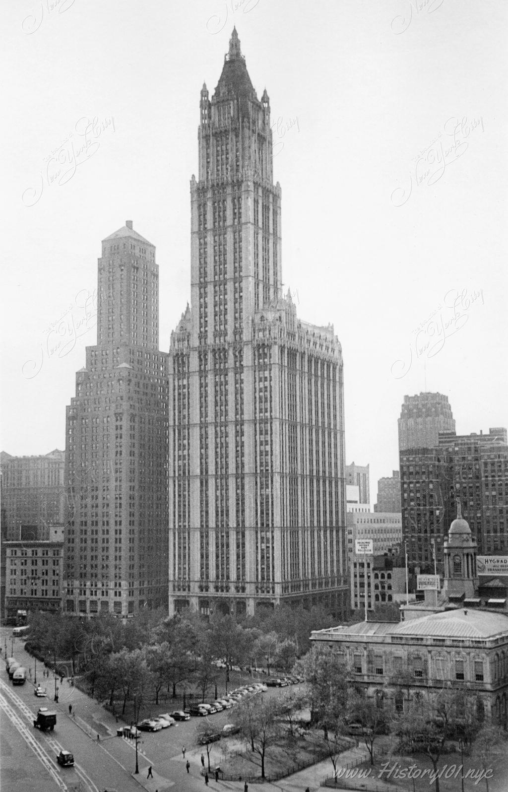 Photograph shows the Woolworth building from across Broadway Street.