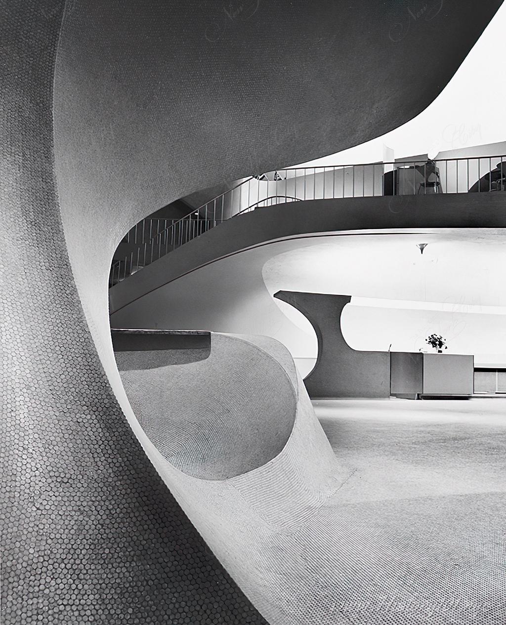 Photograph of TWA Terminal Interior. On the left we see the mezzanine support structure with ticket counters beyond the right.