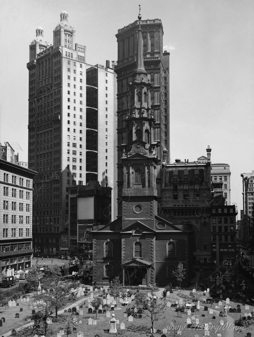 Historic American Buildings Survey photograph showing the church yard of St. Paul's Chapel from the west, framed by Broadway & Fulton Streets.