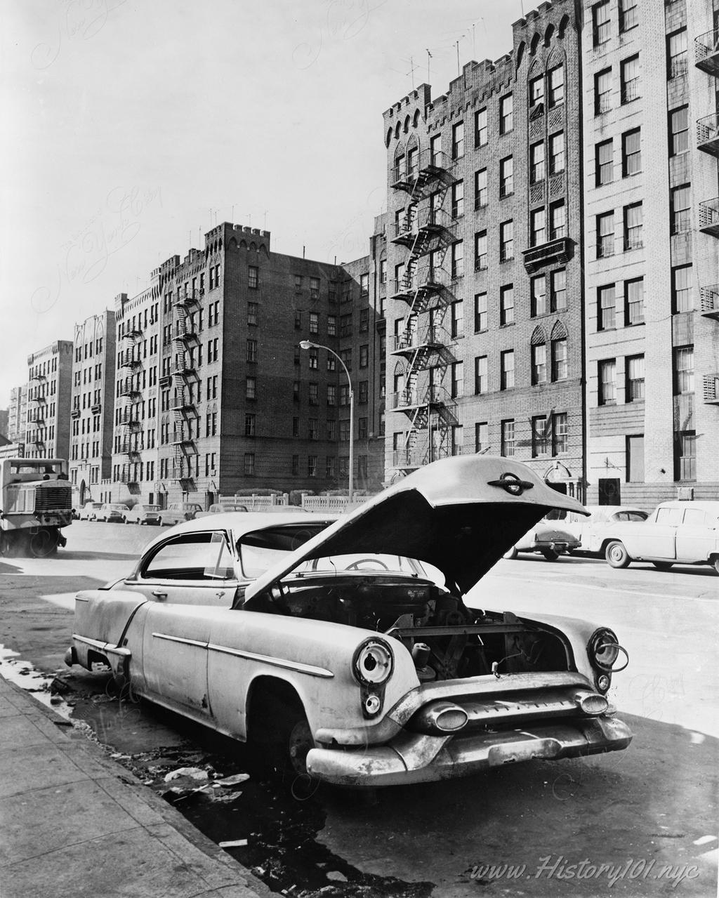 Photograph of an abandoned car on Macombs Road in the Bronx, New York City.