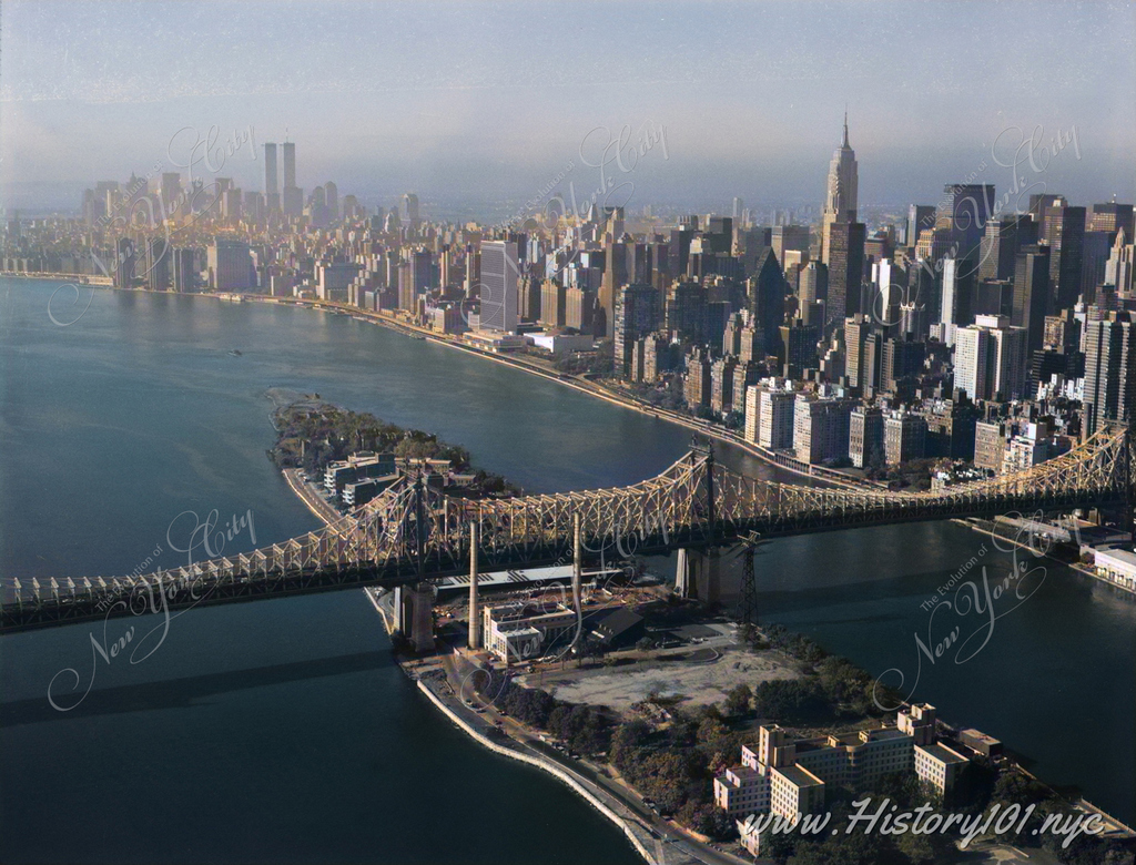 A bird's eye view of the Queensboro Bridge, Spanning East river & Blackwell's Island, with Manhattan's iconic skyline in the background.