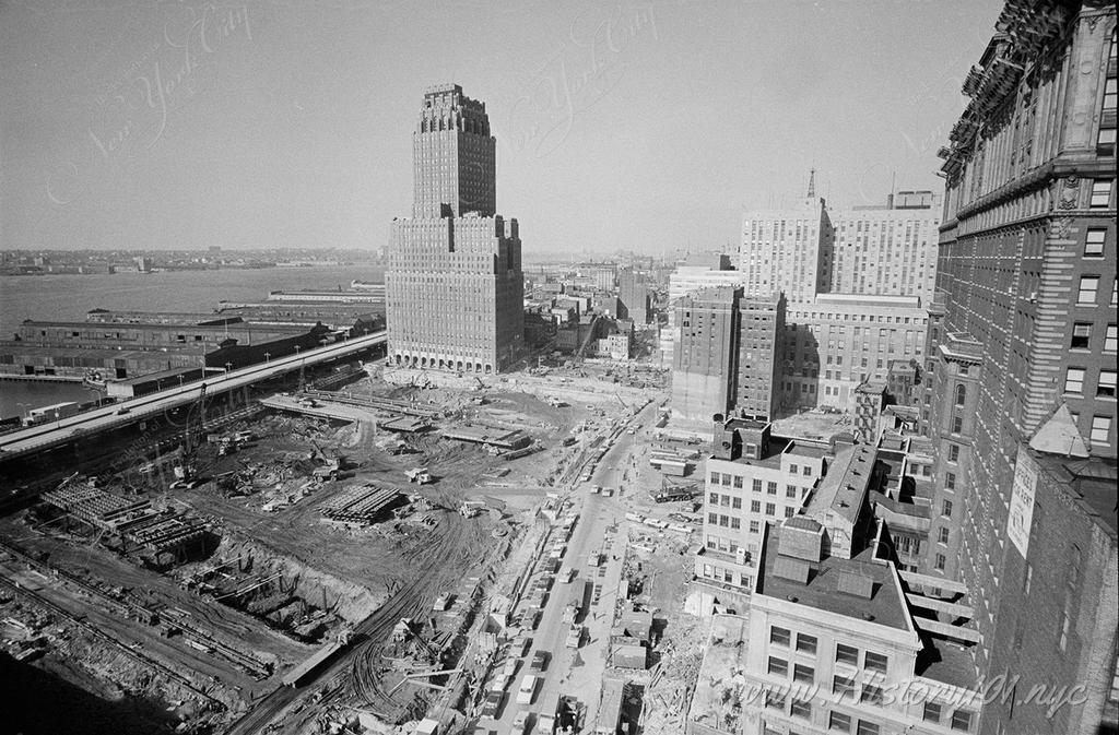 A bird's eye view of the future site of the World Trade Center. An excavator is seen clearing and leveling land and preparing the foundations of the Twin Towers.