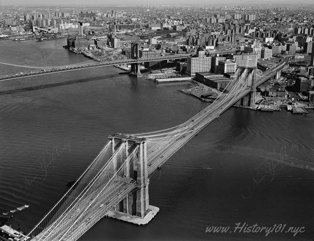 View looking East of the Brooklyn Bridge, spanning the East River between Park Row, Manhattan and Sands Street, Brooklyn.