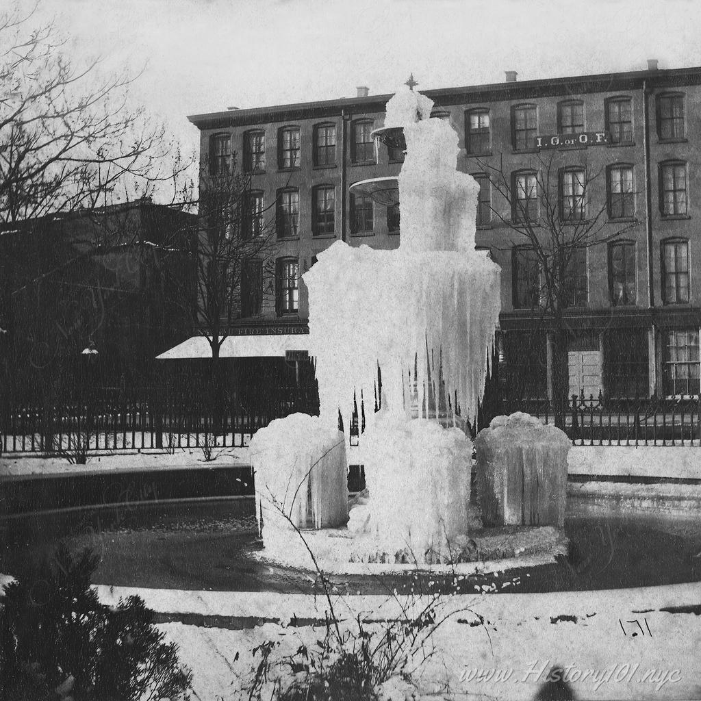 Photograph of a frozen fountain in a Brooklyn neighborhood during the winter.