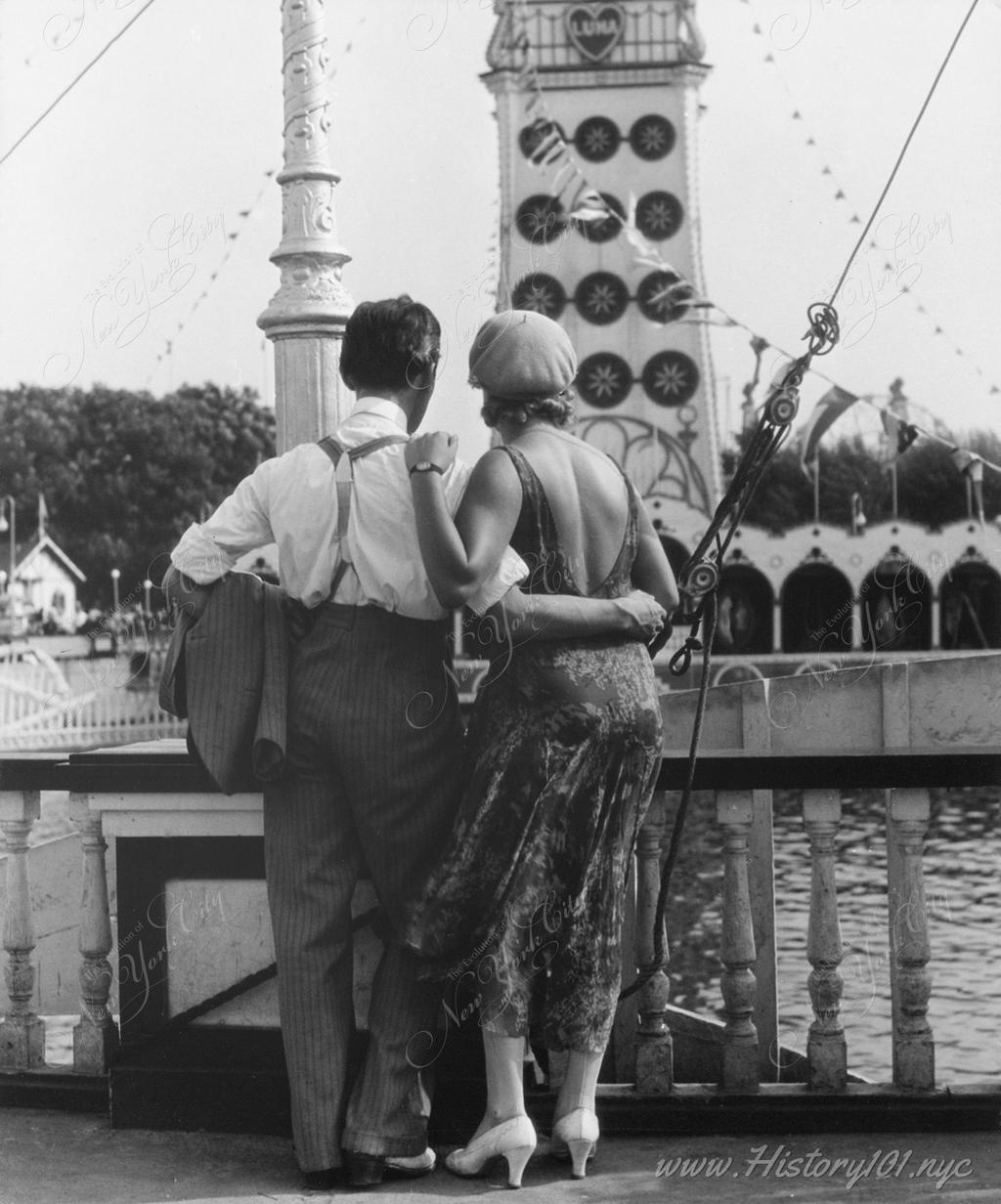 Photograph of a young couple holding each other at Coney Island's Luna Park.
