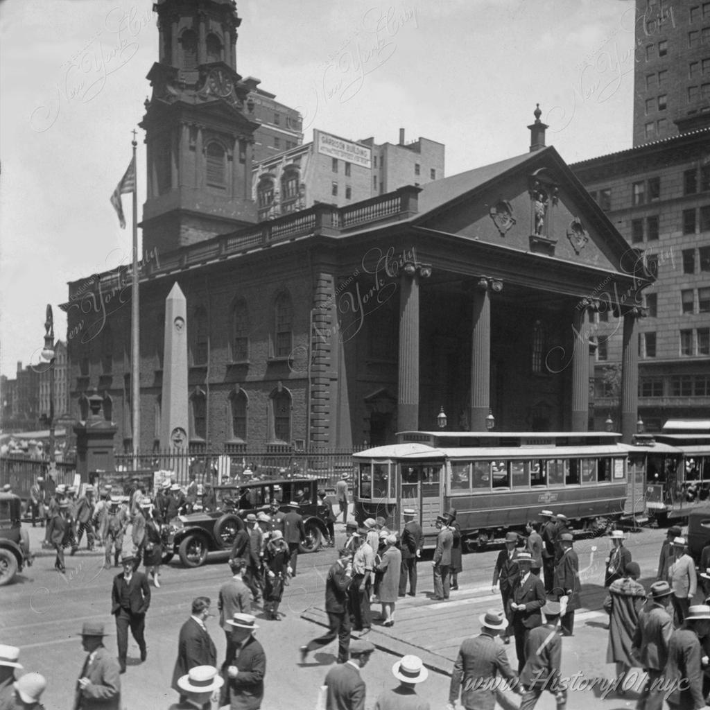 Photograph of a busy street in front of St. Paul's Church, viewed from Broadway.