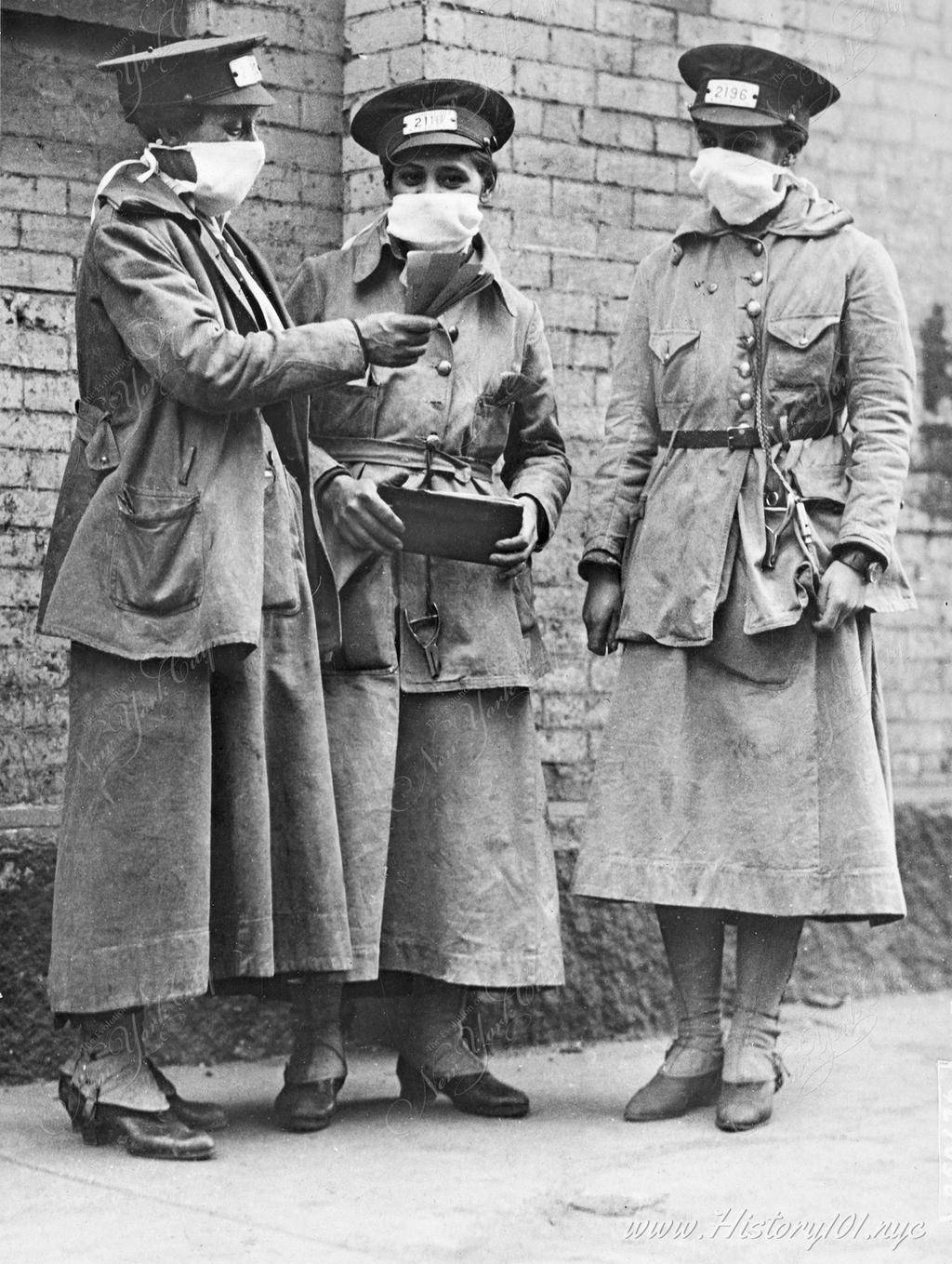 Photograph of female transit workers wearing face masks for protection from the highly contagious and deadly flu which was spread far and wide by the war.