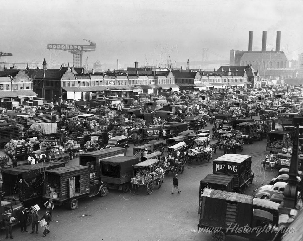 Explore the bustling Wallabout Market in Brooklyn, once NYC's largest food hub, captured in a mix of trucks and horse-drawn carts in the early 20th century