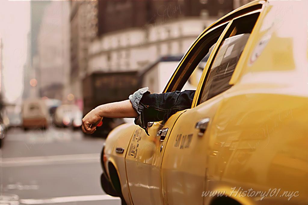 Photograph of a taxi driver with his arm hanging outside the window in Downtown Manhattan traffic.