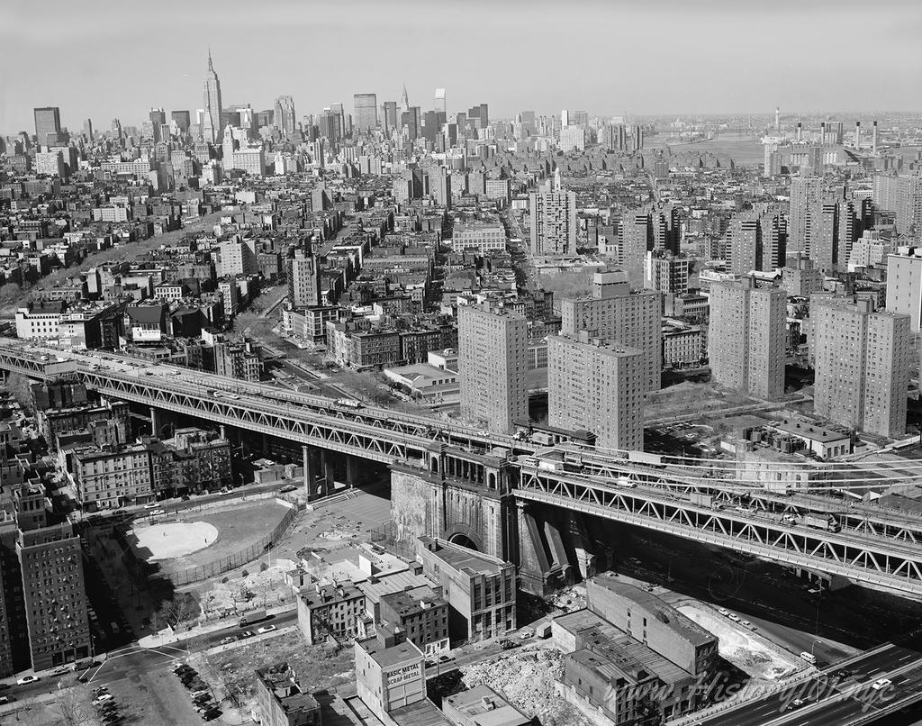 Aerial photograph of the Lower East Side with Midtown Manhattan in the distance.
