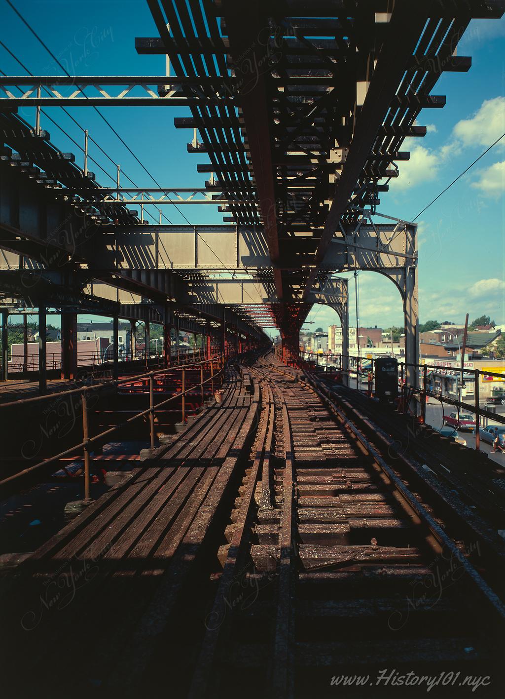 Color photograph of the Third Avenue Elevated Railroad tracks on a clear day.