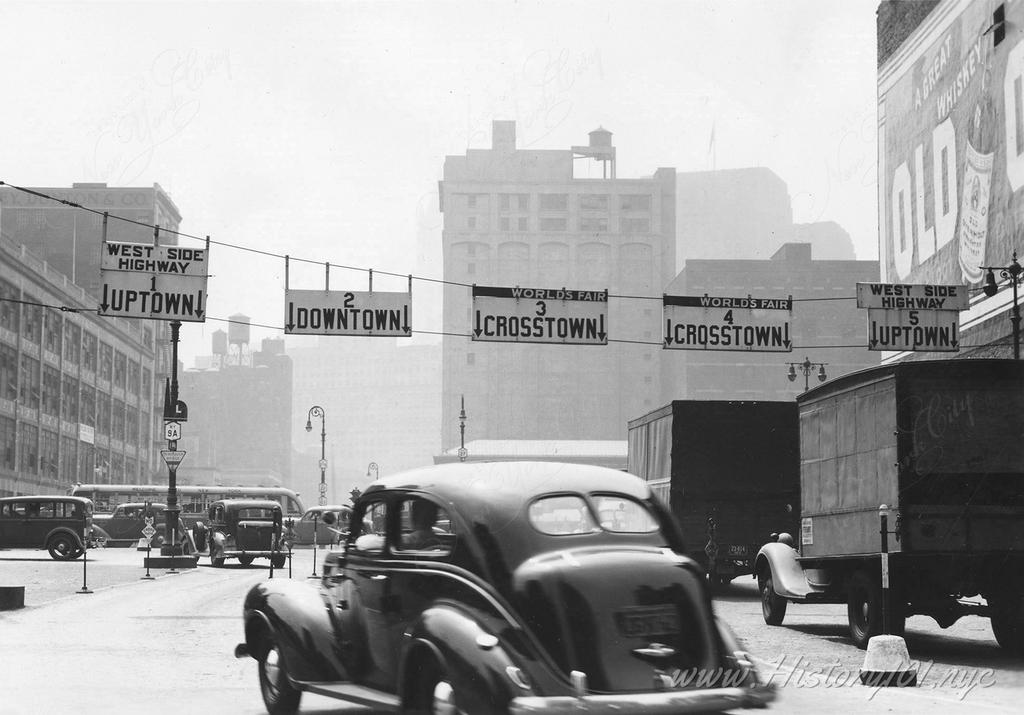 Phtograph of cars exiting the Holland Tunnel on Varick Street, looking south.