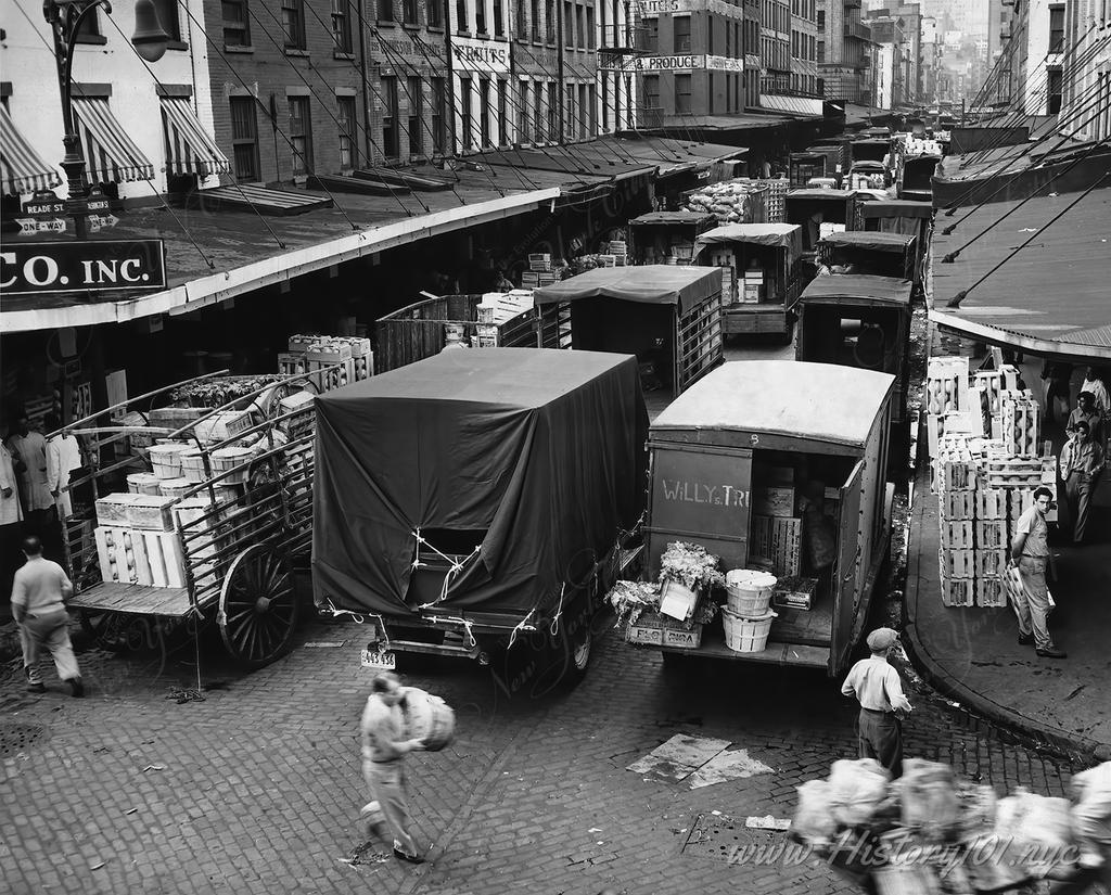Photograph of long lines of trucks being loaded with produce at Washington Market.