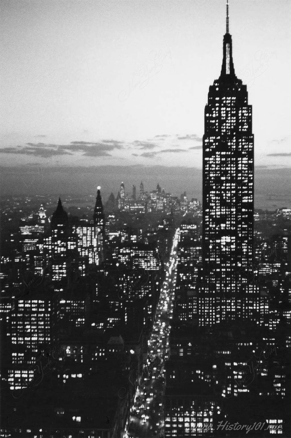 Aerial photograph of the Empire State Building illuminated at night.