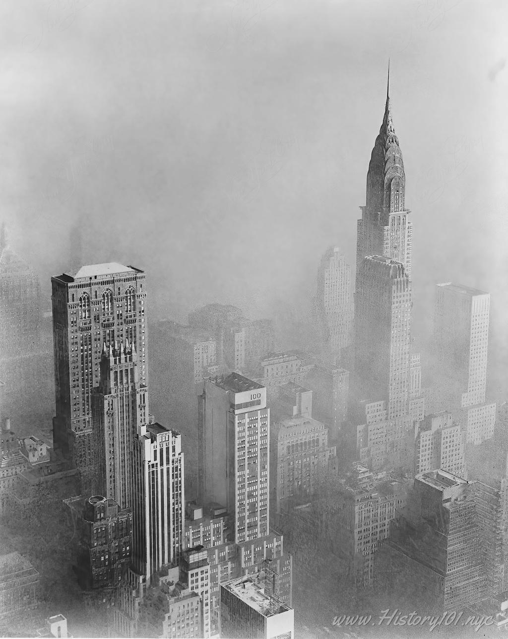 Aerial photograph of smog obscuring a view of the Chrysler Building from the Empire State Building.