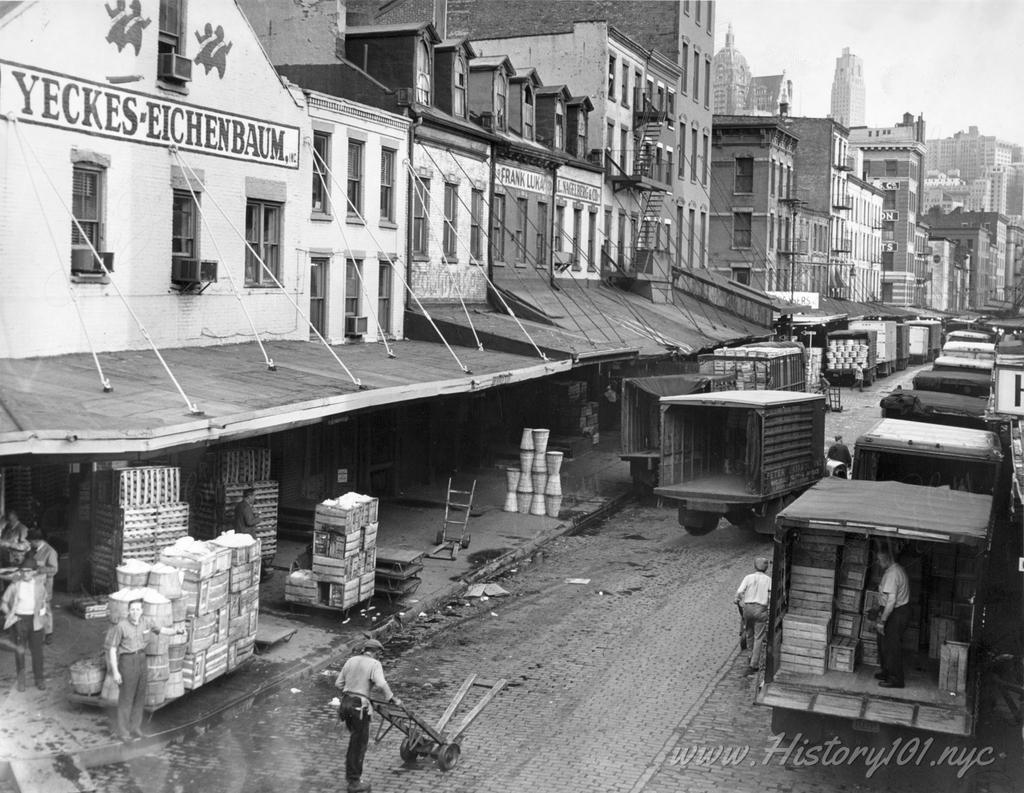 Photograph of trucks being loaded with produce at Washington Market in Downtown Manhattan.