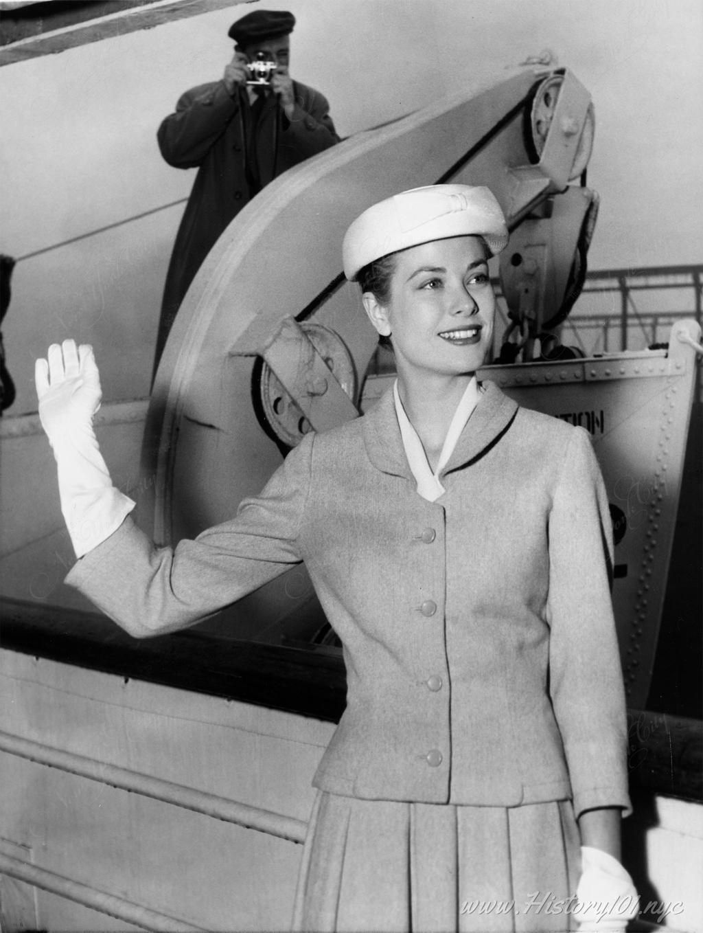 A radiant-looking Grace Kelly waves good-bye to New York from the ocean liner Constitution before sailing for Monaco and her wedding to Prince Rainier.