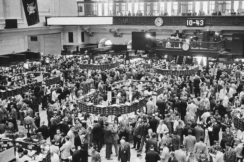 Photograph of a packed floor at the New York City Stock Exchange on Wall Street.