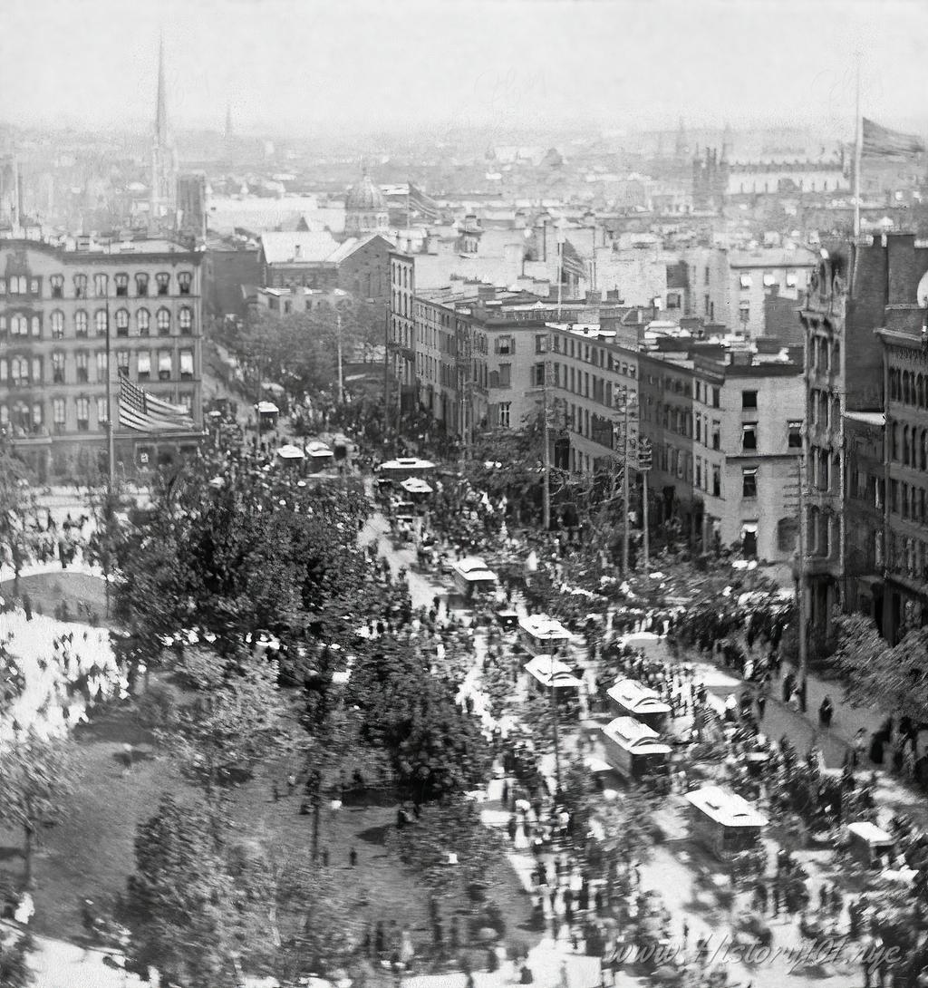 A northeast view of Union Square and 4th Avenue crowded by  trolleys and pedestrians during peak hours.