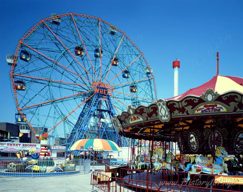Photograph of the Wonder Wheel and Carousel ride at Coney Island in Brooklyn, New York.