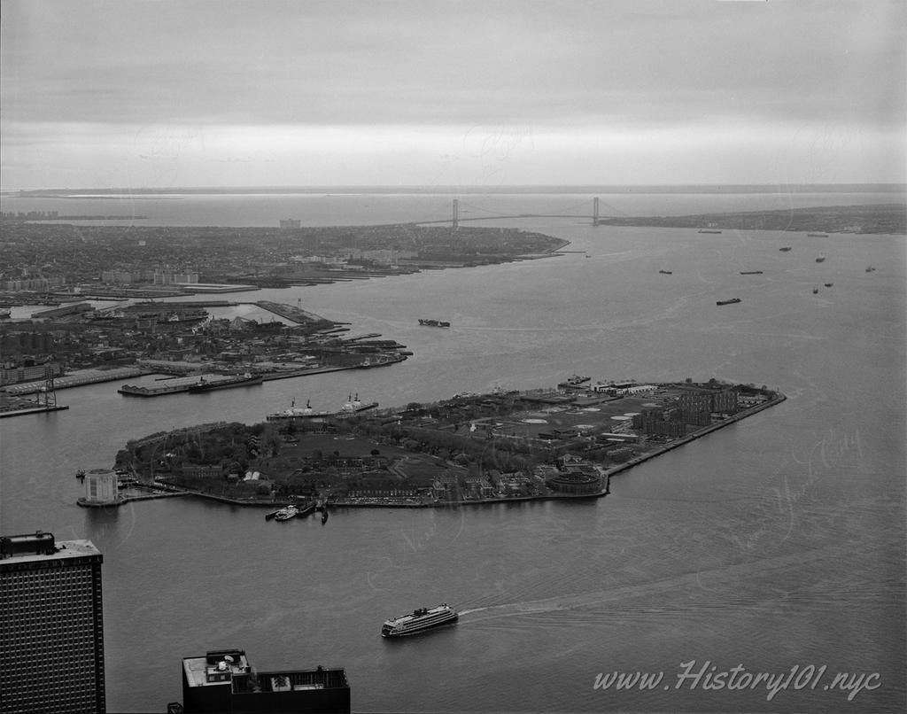 Photograph of Governors Island and New York Harbor with the Twin Towers in the background.
