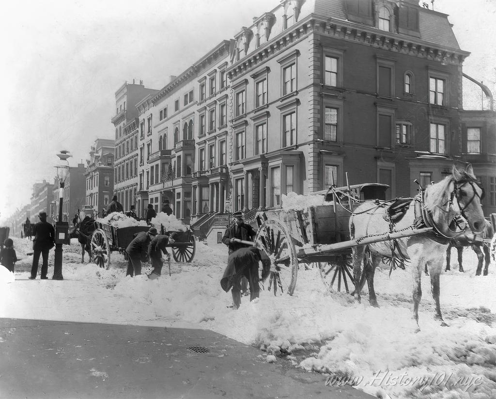 Photograph of the streets after a blizzard, snow carts have been deployed to clear the roads for traffic.