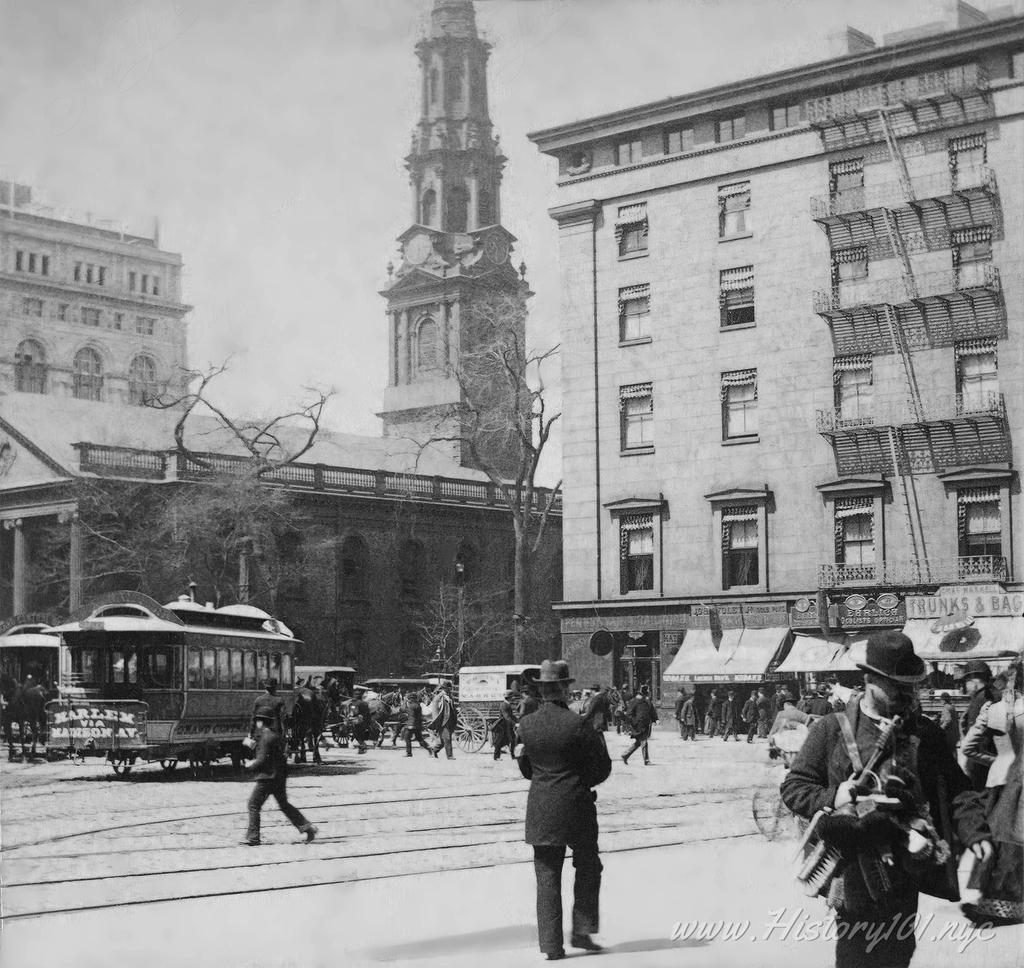 Photograph of a busy street in front of Saint Paul's Church and Astor House.