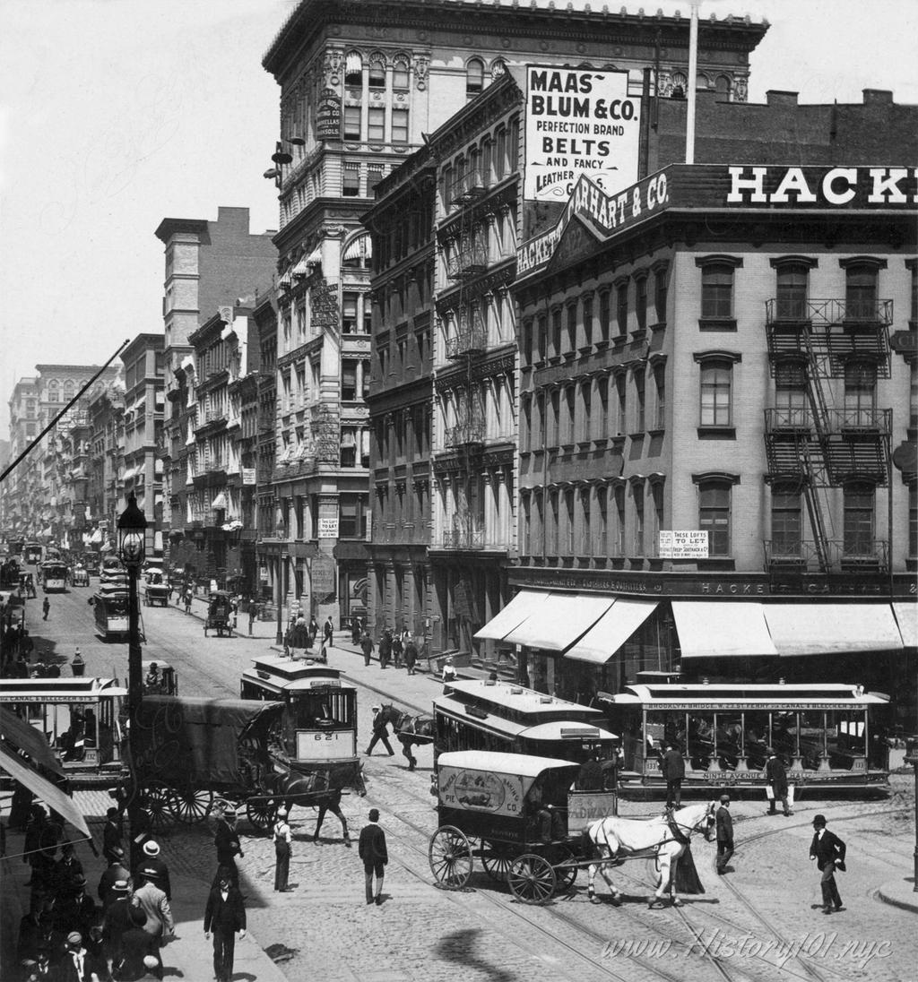 Photograph of traffic on the corner of Canal Street and Broadway.