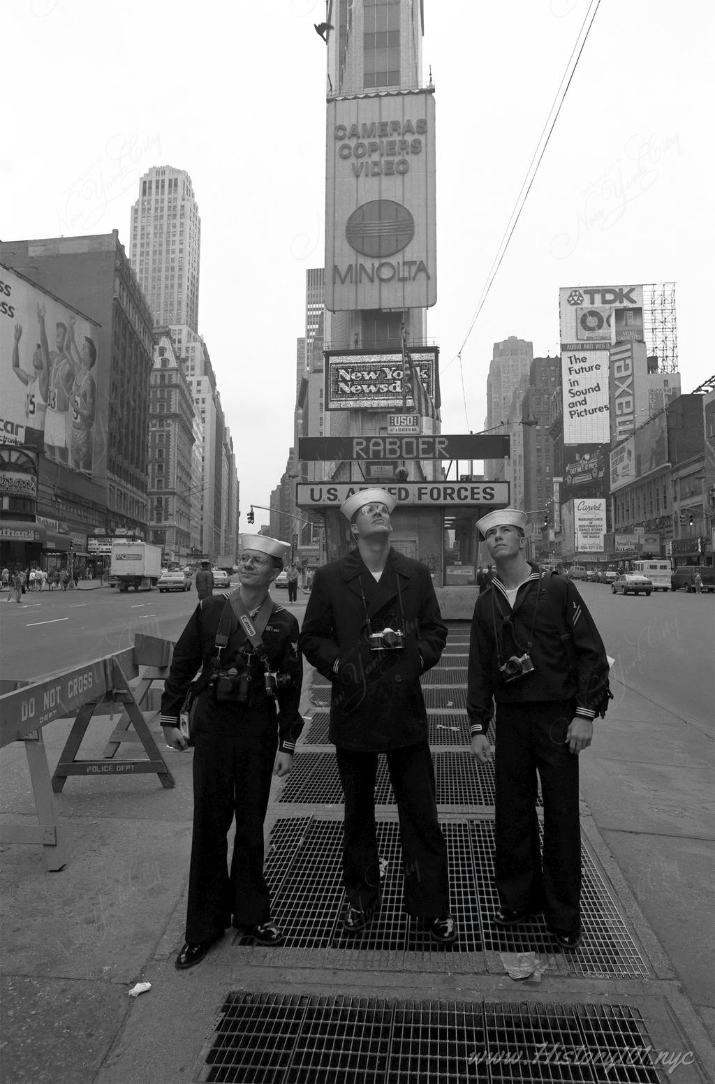 Explore the intersection of military tradition and commercial culture in Times Square, as sailors gaze at iconic billboards during Fleet Week in New York City