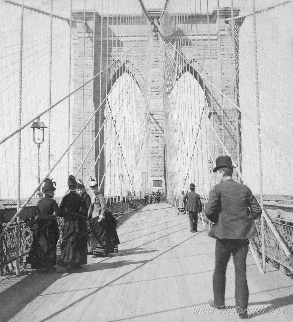 An early photograph of the recently opened Brooklyn Bridge promenade - a much needed connection between Manhattan and Brooklyn.