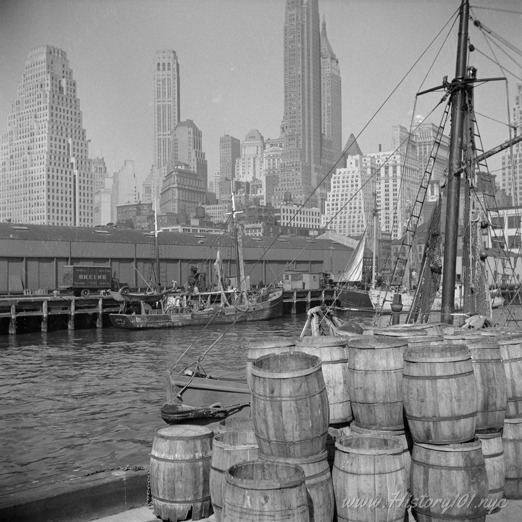 Photograph of empty barrels, stacked and ready for loading at the Fulton Fish Market.